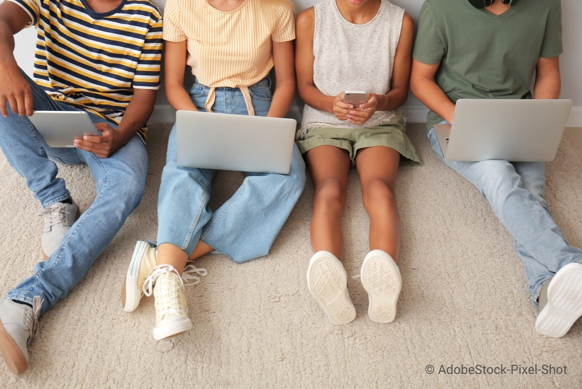 A group of four happy children doing a workshop together.