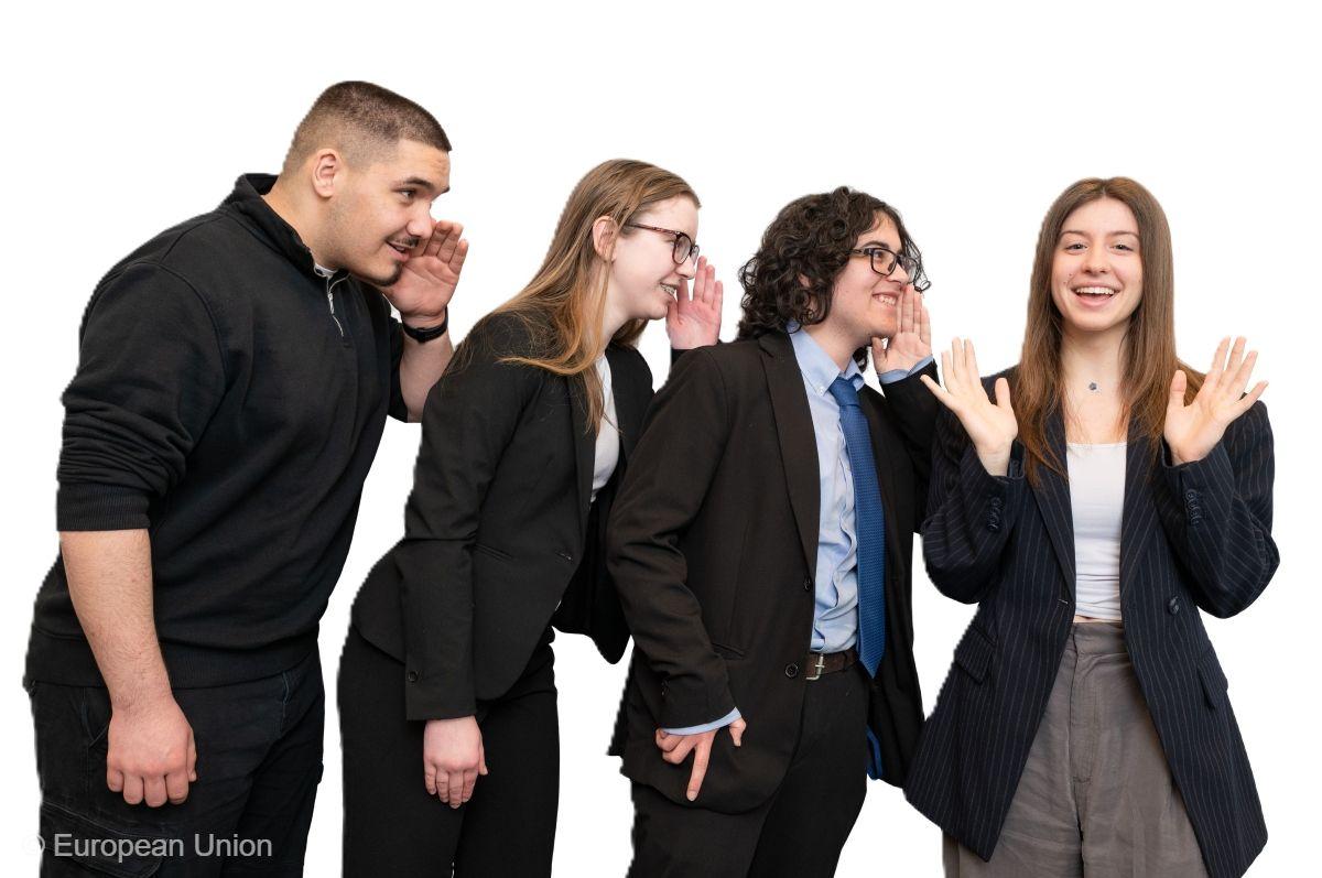 Four young Europeans whispering into each other's ears.